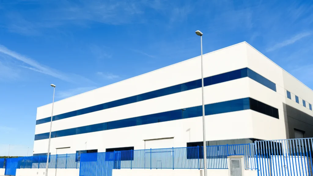 Two-story office and warehouse building featuring blue accent banding