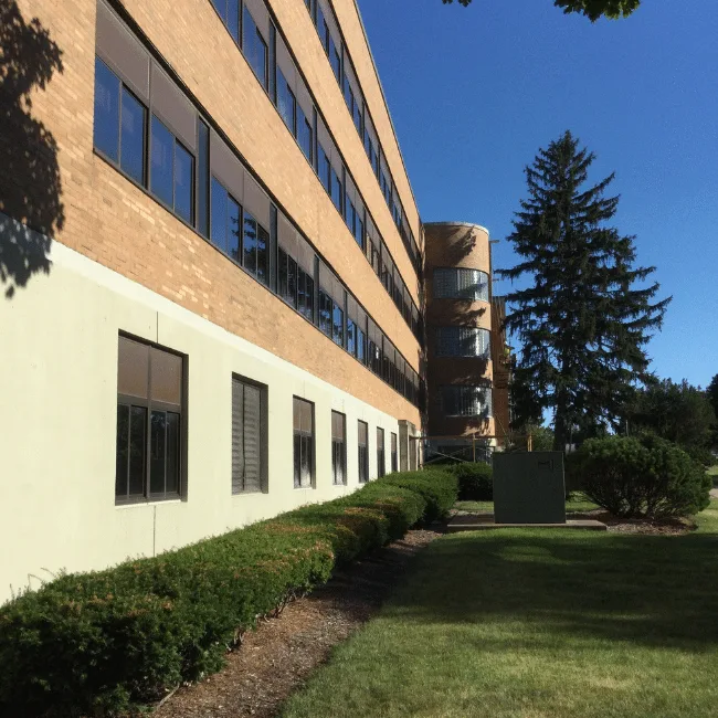Multi-story office and laboratory building renovation with mature landscaping, Grayslake, IL