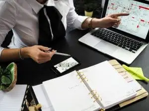 Owner reviewing building plans at a desk with the project team