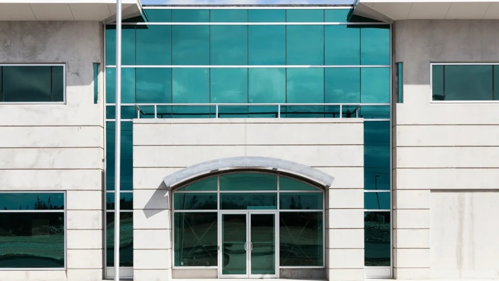 Pre-cast concrete office façade featuring an arched glass entry