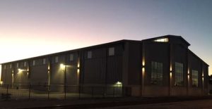 Exterior of the completed boat sales and storage facility at dusk