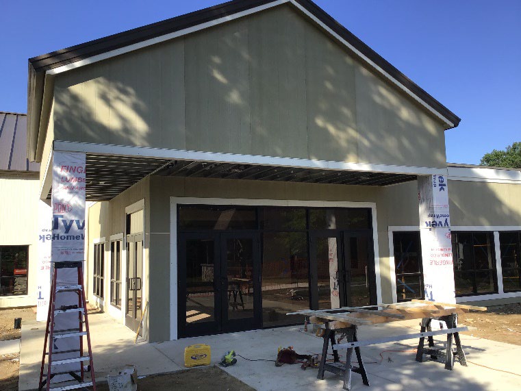 Church addition under construction with a new entrance canopy and windows in Dexter, Michigan