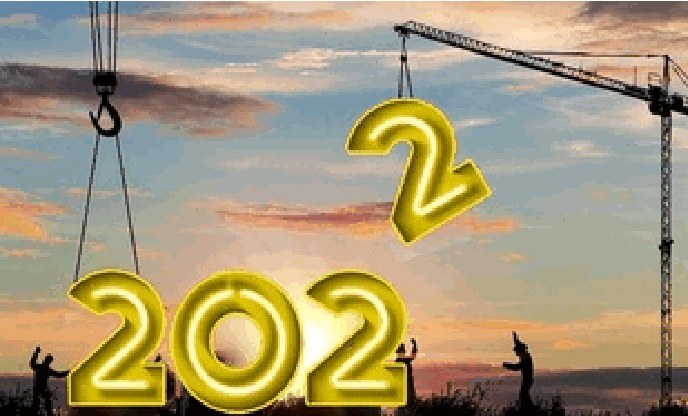 Gold 2022 balloons lifted by a crawler crane over a construction site at sunset