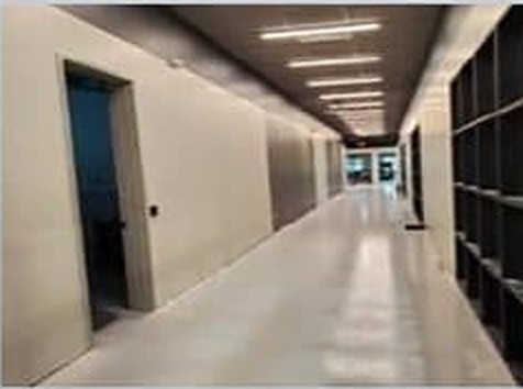 Corridor of the completed Phase 1 buildout, with polished floors and an open ceiling