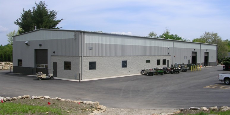 Long single story metal maintenance building with a paved drive in Naperville, Illinois